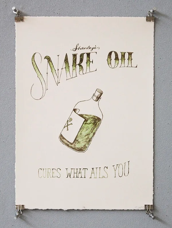 Letterpress label print reading ‘Stanley's Snake Oil, cures what ails you’ in olive green ink with an ornate bottle illustration